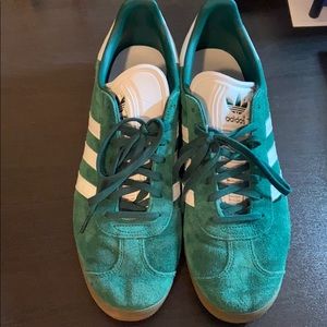 Green Adidas Gazelle sneakers.